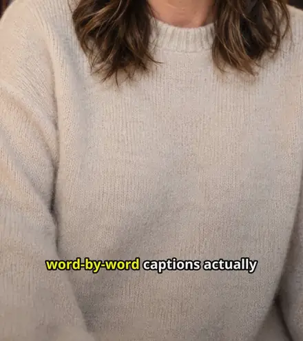 A frame of captioned video in the Pop style, with the words "word-by-word captions actually" across the lower third and the current word highlighted